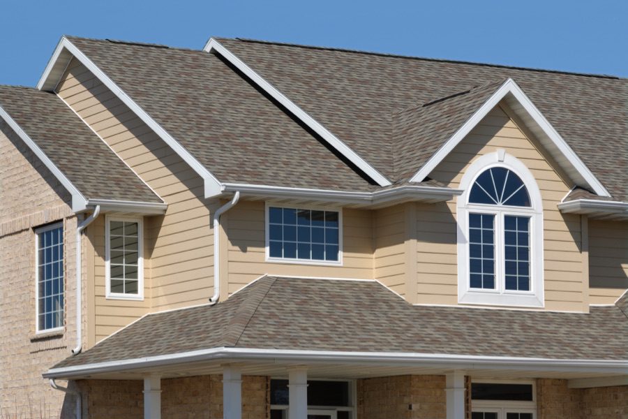 home with shingle roof and tan siding